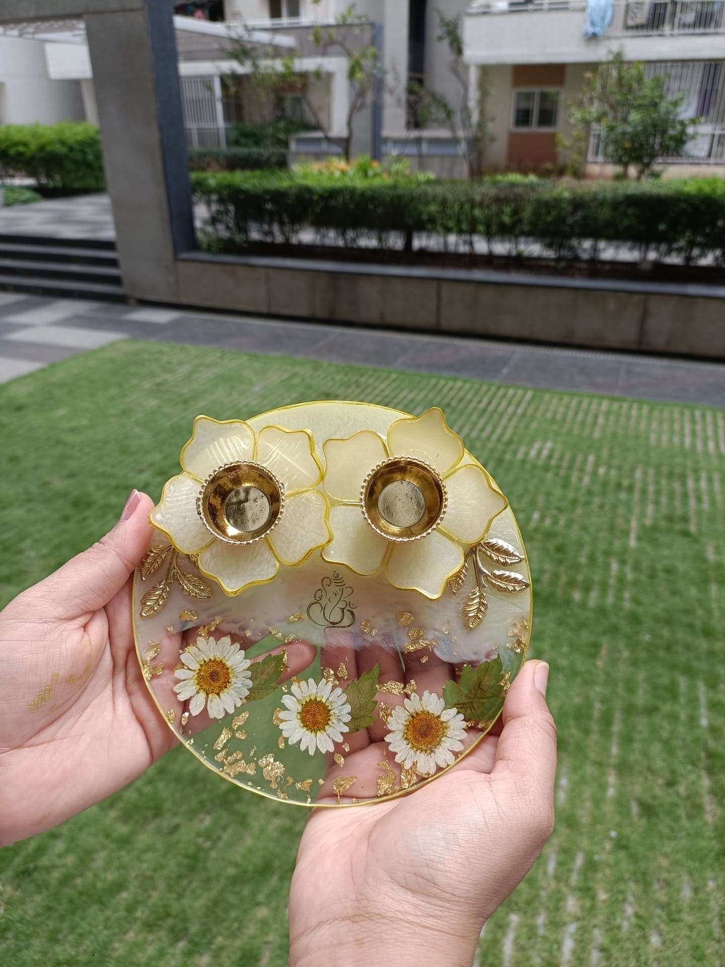 Resin pooja thali with pressed daisies, gold leaf and two diya holders