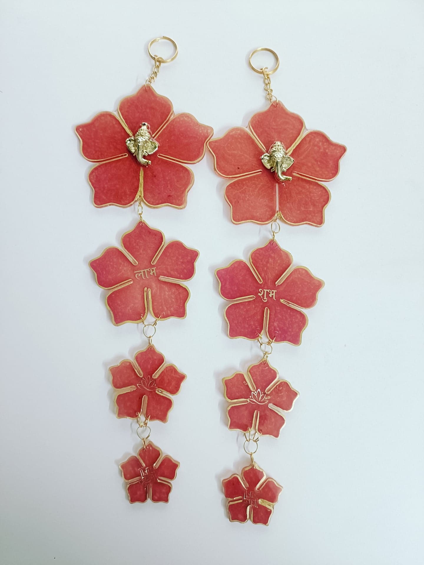 Pair of coral-pink floral resin hangings with Ganesha and Shubh Labh