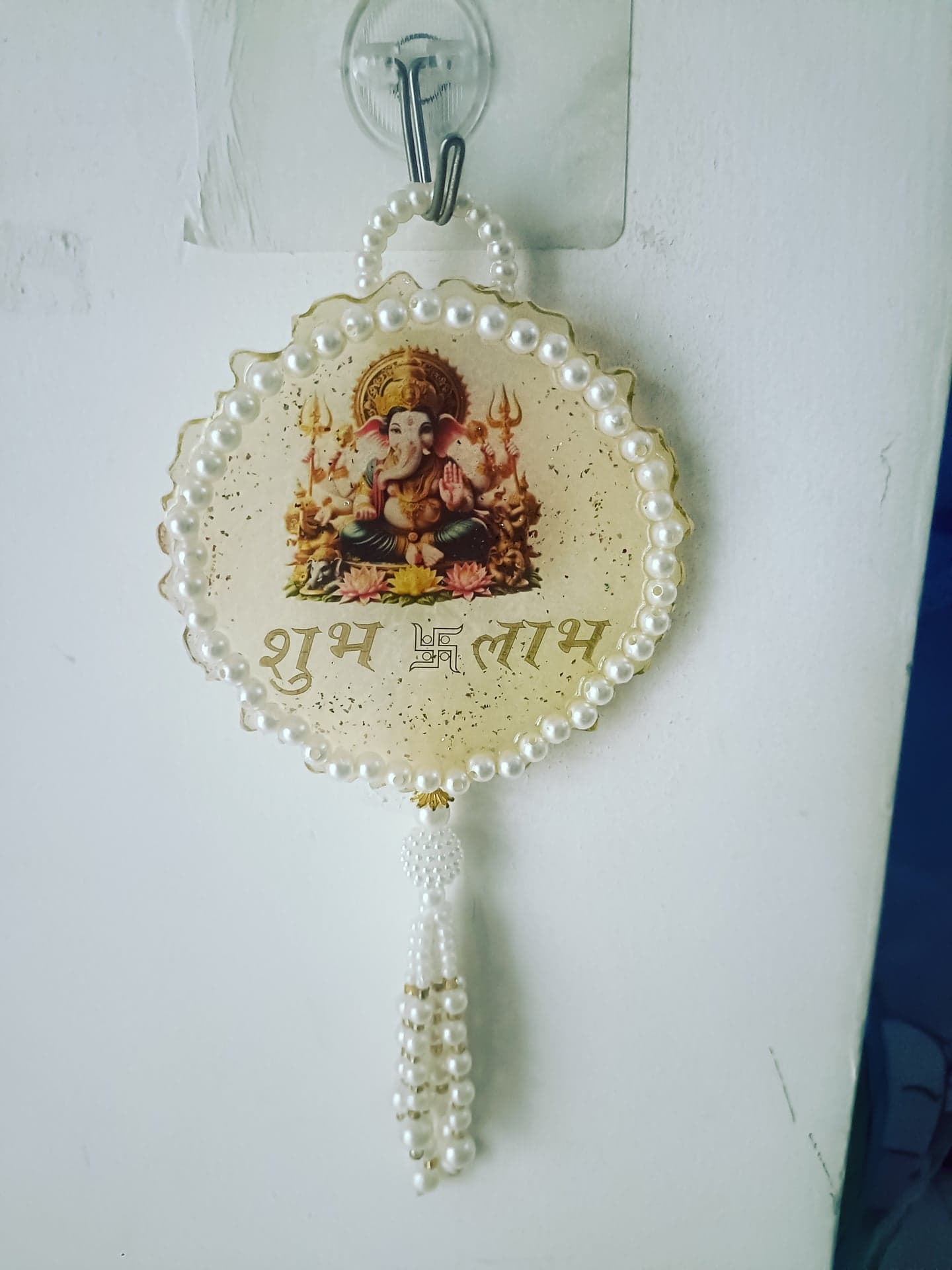 Cream resin Ganesha wall hanging with pearls and Shubh Labh