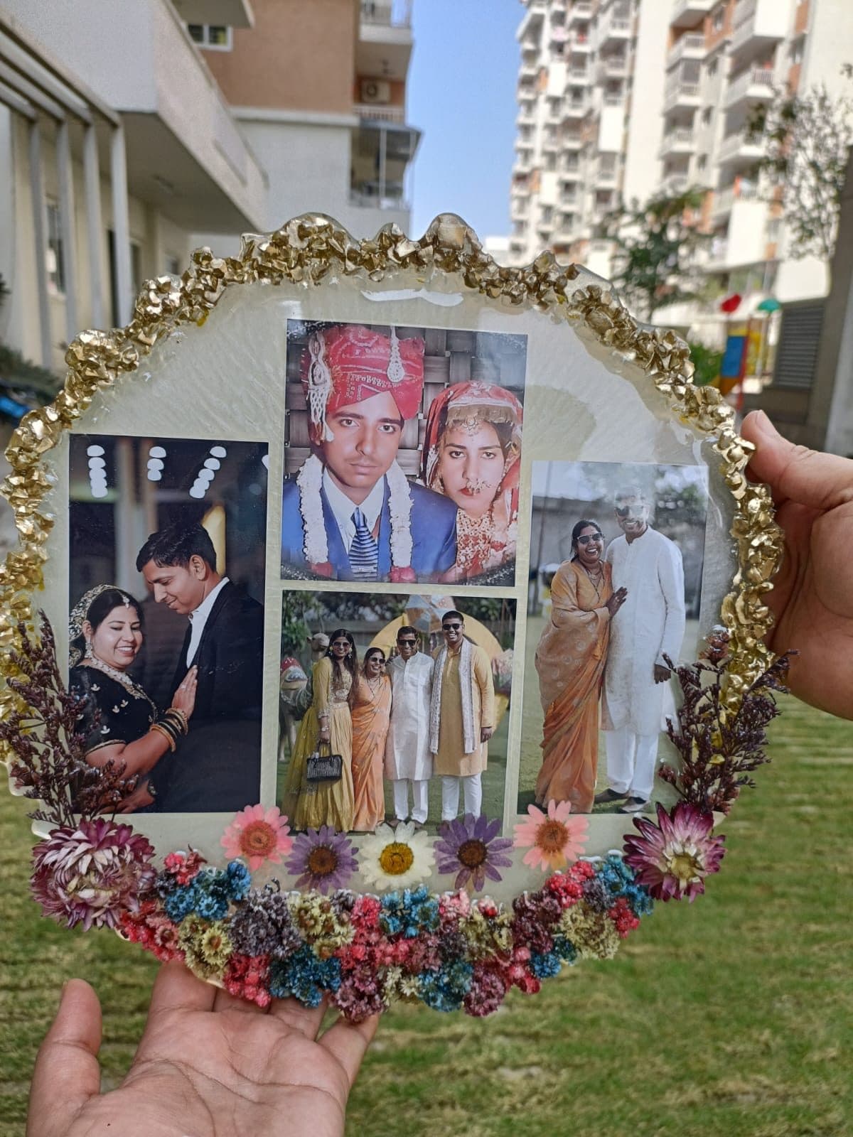 Round floral resin frame holding a collage of family photographs