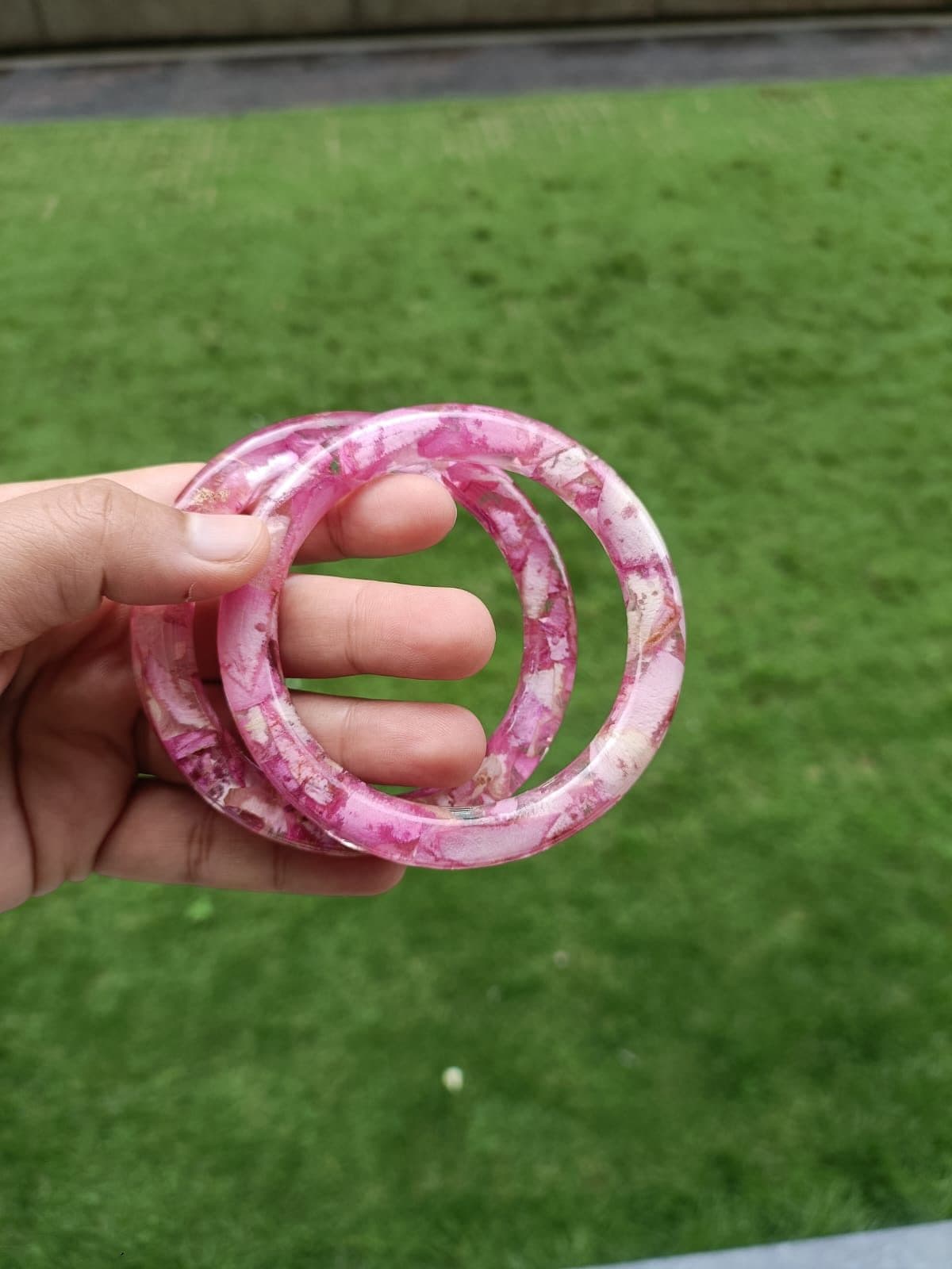 Stack of pink and purple marbled resin bangles