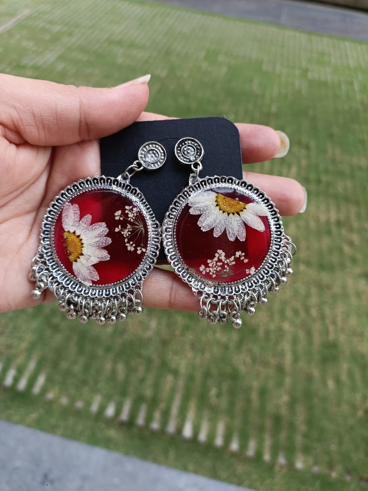 Red floral jhumkas with a silver fringe